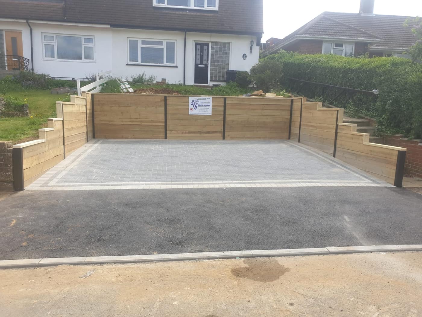 Block paved driveway with sleeper retaining walls