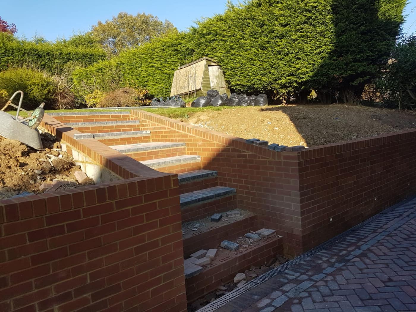 Brick retaining wall and steps under construction