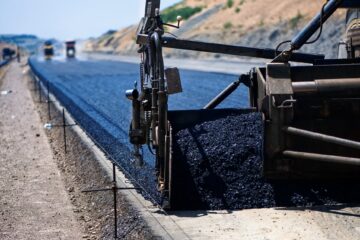 industrial pavement truck laying fresh asphalt on construction site Road Surfacing near me Kent